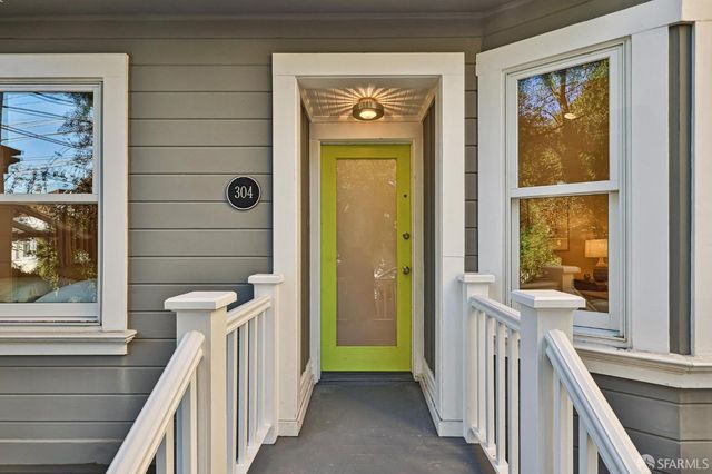 a living room with furniture potted plant and large windows