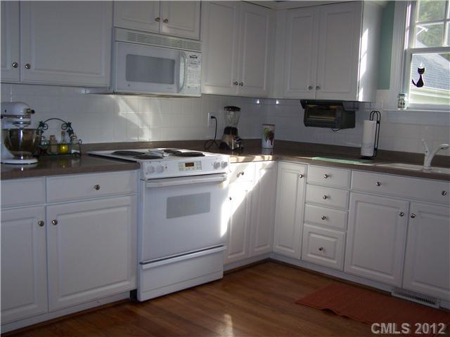 112 Morrison Hill Road Davidson, NC 28036 - Photo 5 of 13 a kitchen with white cabinets and white appliances