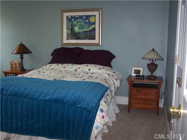 112 Morrison Hill Road Davidson, NC 28036 - Photo 10 of 13 a bedroom with a bed and a lamp on dresser