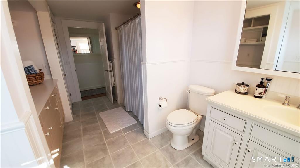 12 Flower Avenue Madison, CT 06443 - Photo 14 of 24 a bathroom with a sink toilet and shower