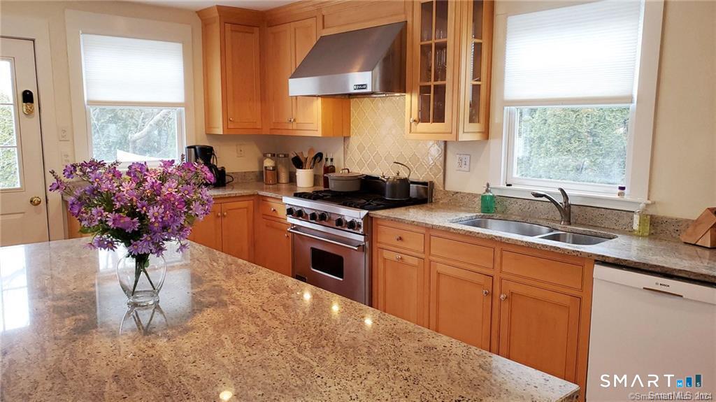 12 Flower Avenue Madison, CT 06443 - Photo 21 of 24 a kitchen with stainless steel appliances a sink a stove and a wooden floor
