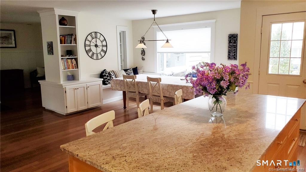 12 Flower Avenue Madison, CT 06443 - Photo 3 of 24 a living room with furniture a window and wooden floor