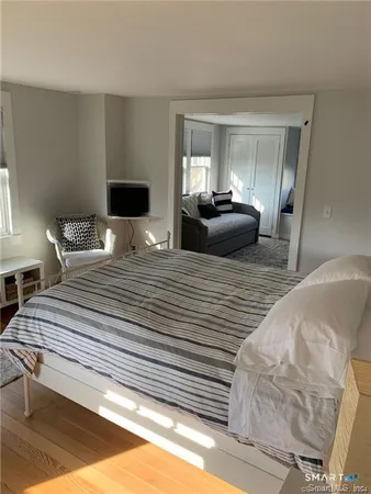 a bedroom with double bed and a large window