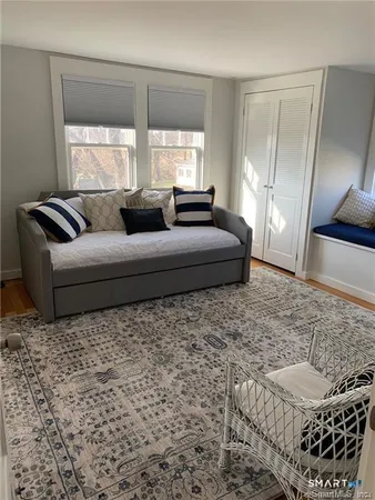 a living room with furniture window and a potted plant
