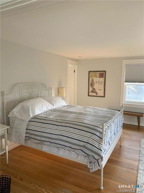 12 Flower Avenue Madison, CT 06443 - Photo 10 of 24 a bedroom with a bed and a night stand
