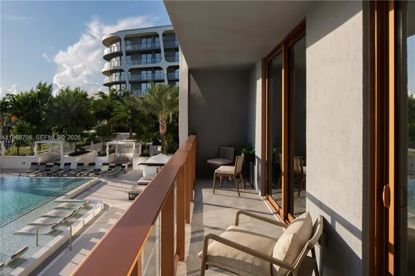 a view of a balcony with two chairs and a table