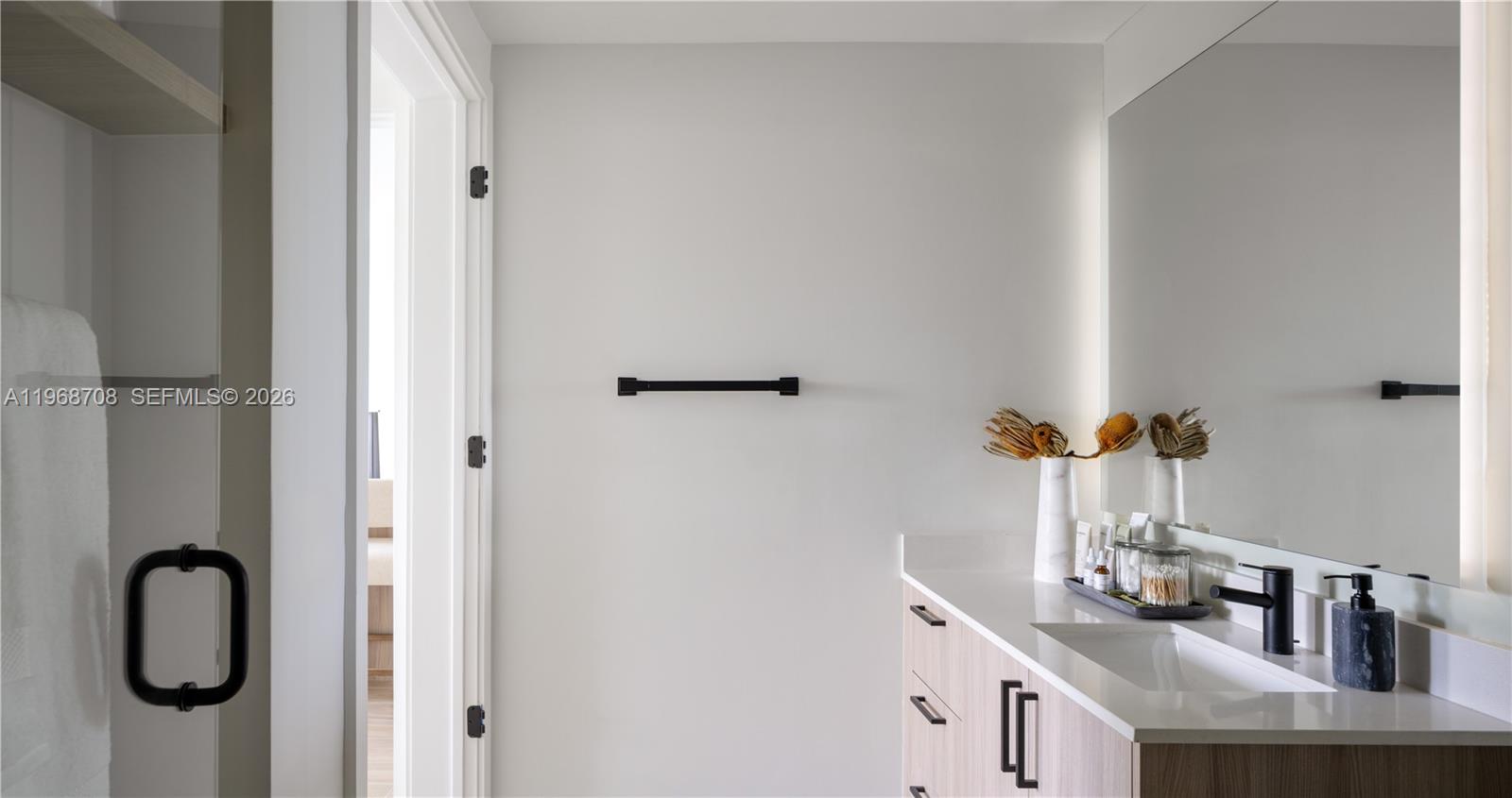3900 Alton Road, Unit 719 Miami Beach, FL 33140 - Photo 9 of 16 a bathroom with a granite countertop sink and a mirror