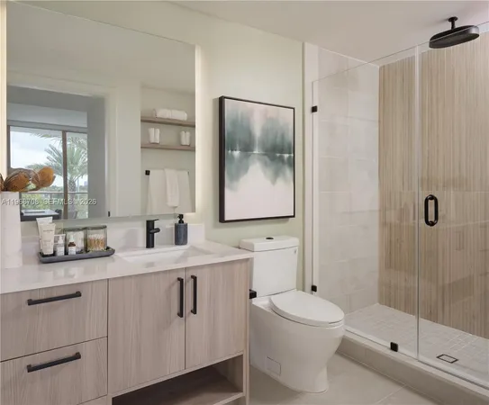 a bathroom with a double vanity sink toilet and shower