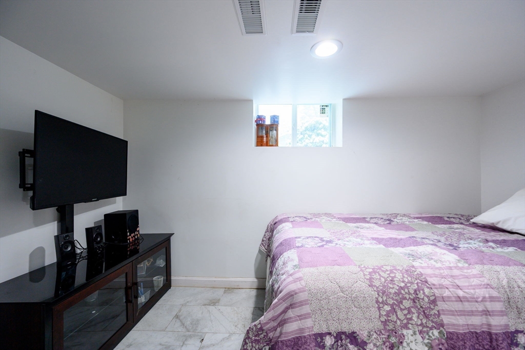 44 Patterson Street Weymouth, MA 02189 - Photo 20 of 27 a bedroom with a bed and a flat screen tv