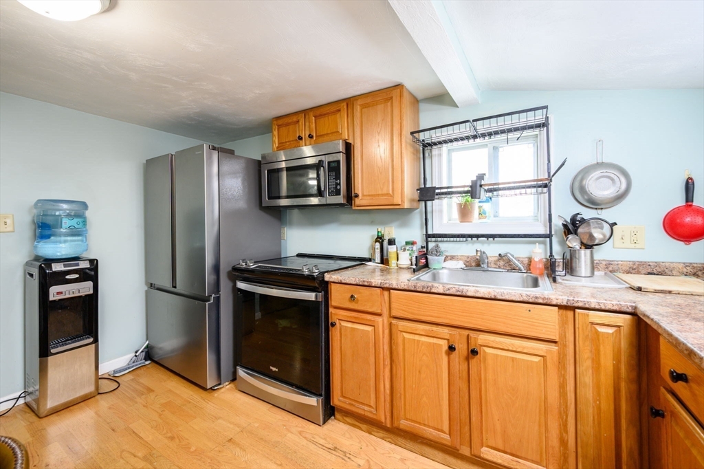44 Patterson Street Weymouth, MA 02189 - Photo 10 of 27 a kitchen with stainless steel appliances granite countertop a refrigerator a stove a sink and a microwave