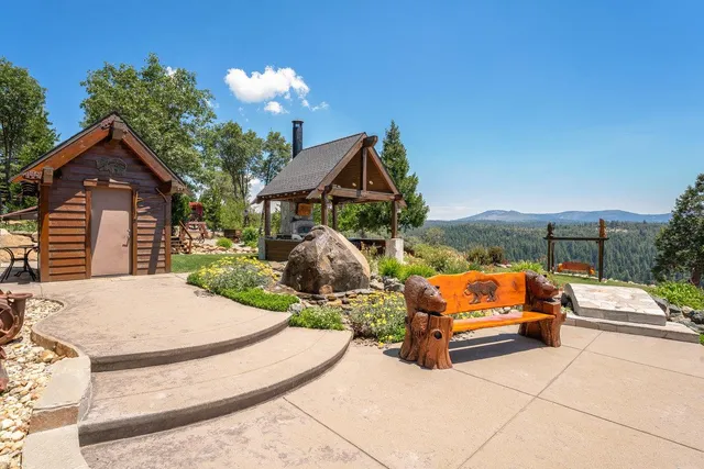 a dining hall with stainless steel appliances granite countertop a stove and a large countertops with wooden floor