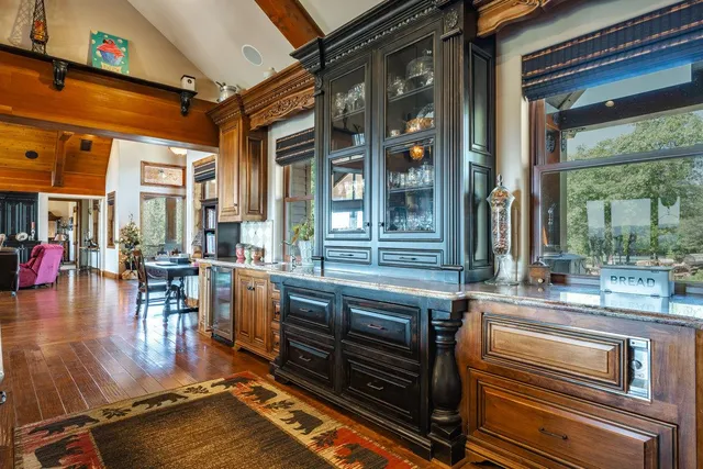 a bedroom with a bed a dresser and wooden floor