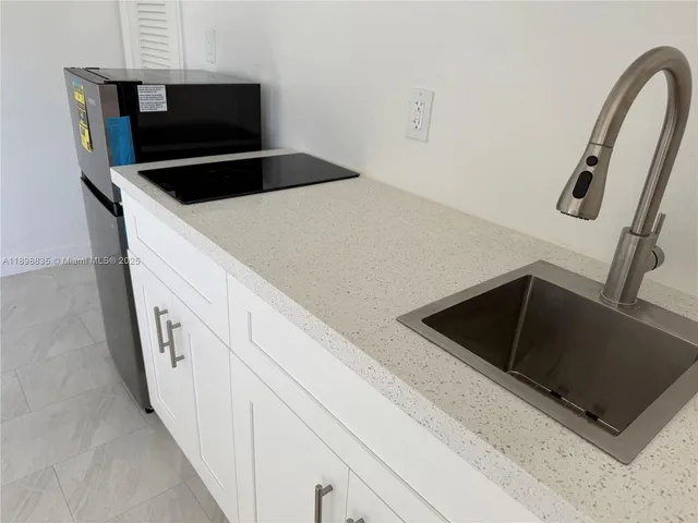a kitchen with granite countertop a stove and a microwave