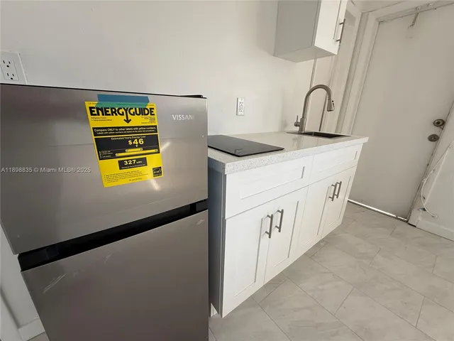 a kitchen with stainless steel appliances granite countertop a sink and a stove