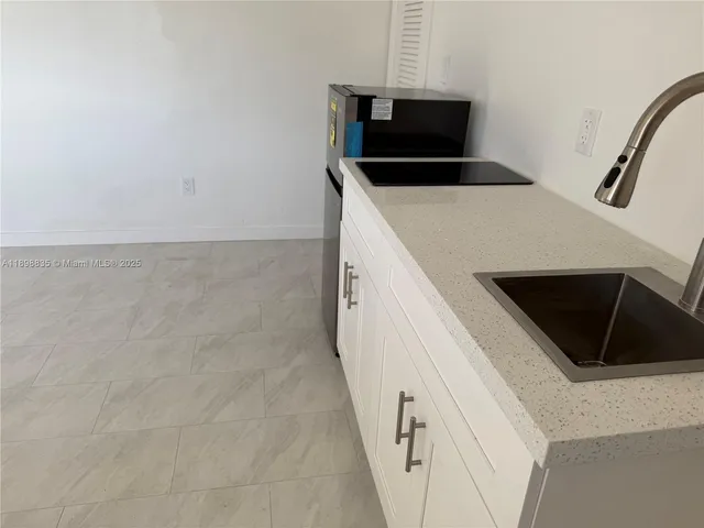 a kitchen with a microwave and a refrigerator