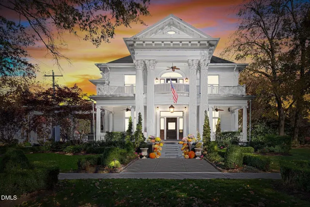 a big yard with table and chairs and a small yard