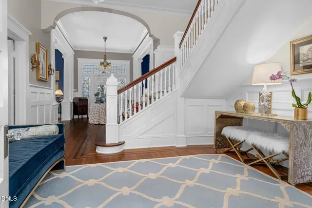 a living room with furniture a chandelier and a fireplace