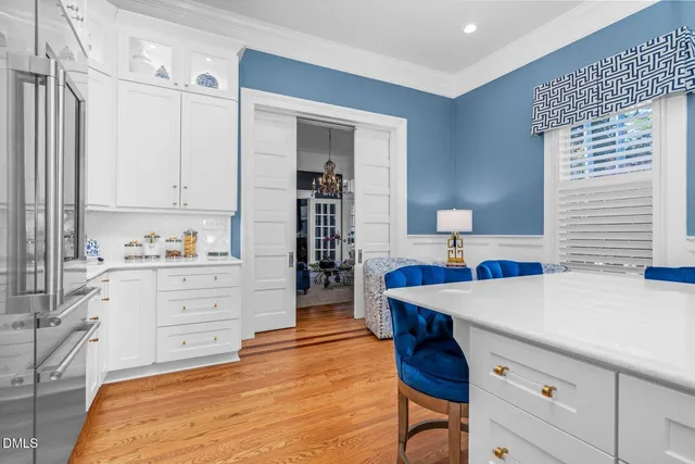 a bedroom with a bed and a flat tv screen on dresser