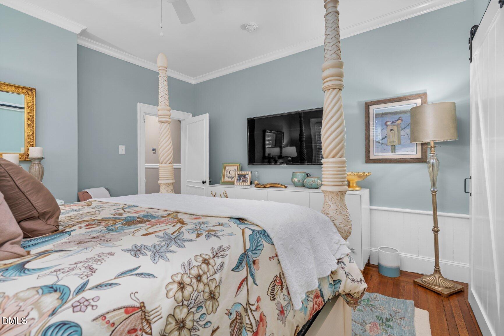 1109 North Main Street Tarboro, NC 27886 - Photo 38 of 90 a bedroom with a bed and a flat tv screen on dresser