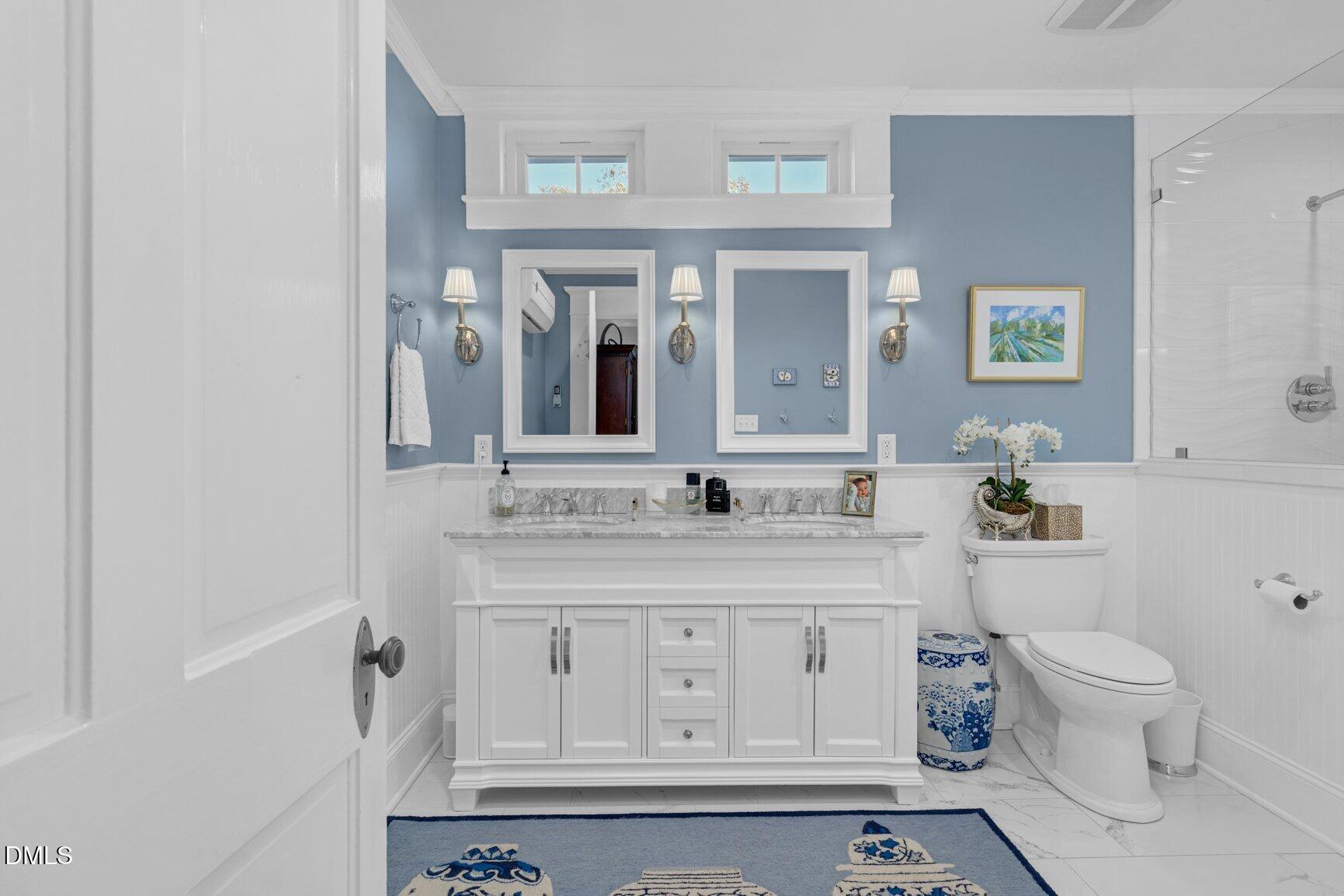 1109 North Main Street Tarboro, NC 27886 - Photo 60 of 90 a bathroom with a granite countertop toilet a sink and a mirror