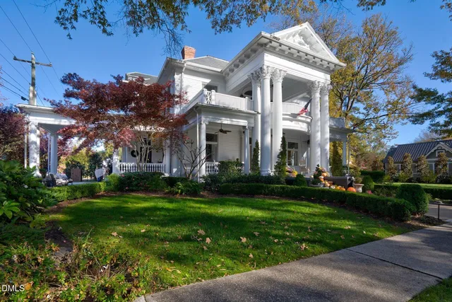 a living room with furniture dining table and a chandelier