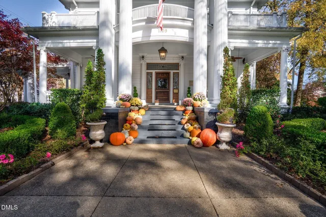 a living room with fireplace furniture and a rug