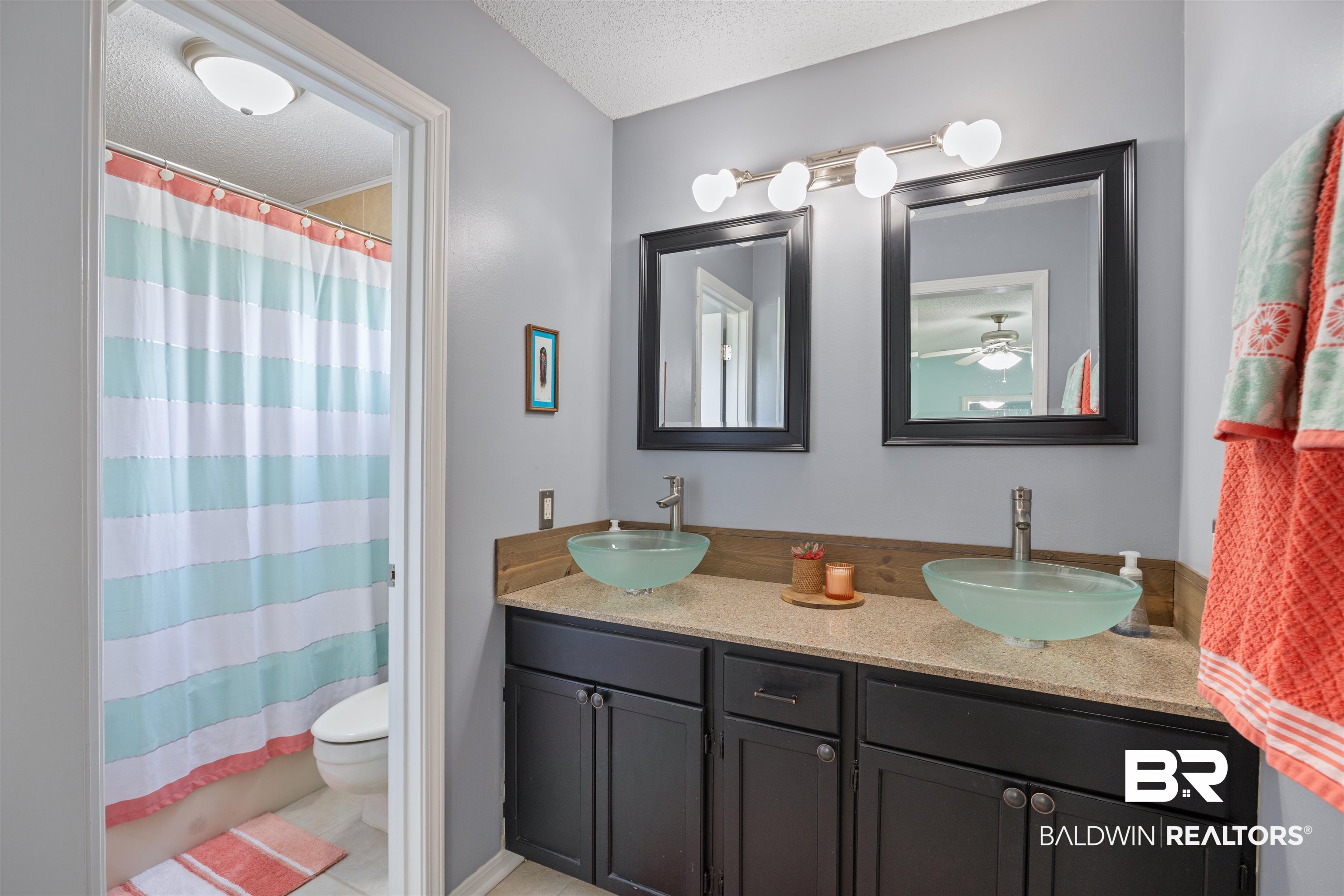 9771 Clarke Ridge Road Foley, AL 36535 - Photo 50 of 72 Full bathroom featuring double vanity, a textured ceiling, toilet, and a sink.