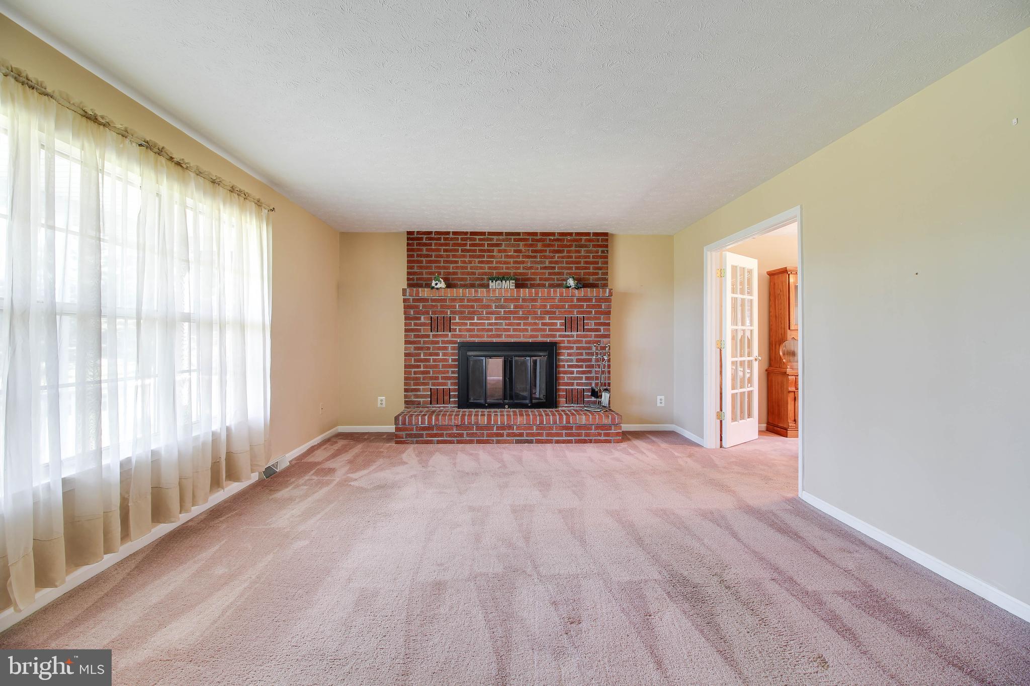 4709 Mt Carmel Road Hampstead, MD 21074 - Photo 2 of 44 wooden floor fireplace and windows in an empty room