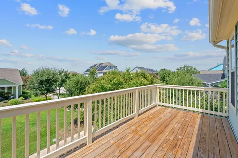 a balcony with wooden floor and fence