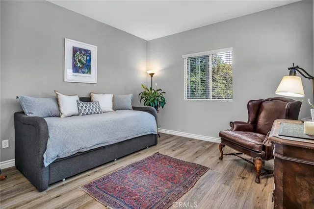 a bedroom with furniture and a rug
