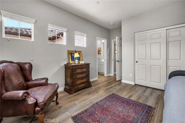 a living room with furniture a dining table a lamp and paintings on the wall