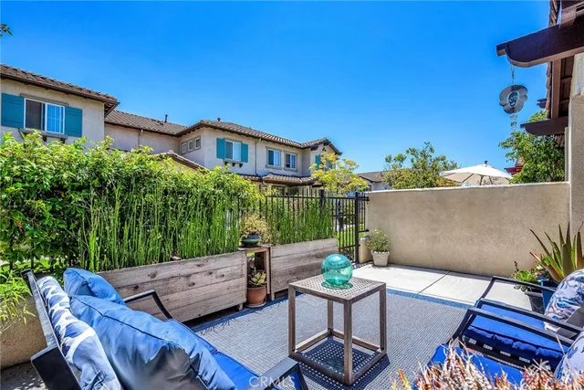 a backyard of a house with table and chairs