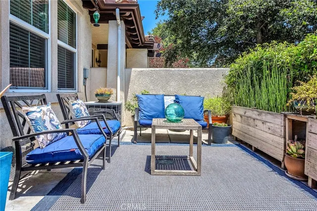 a view of backyard with outdoor seating and trees