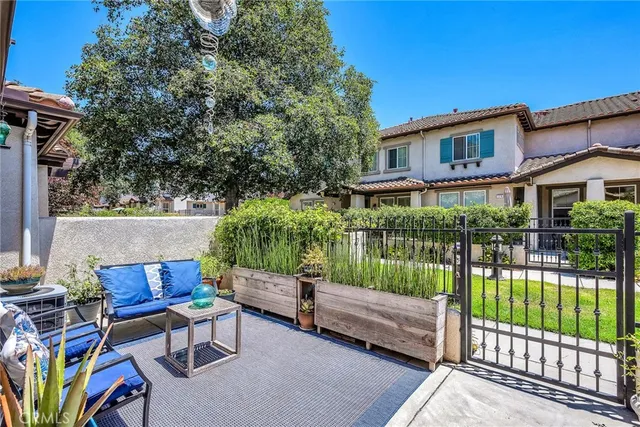 a view of a chair and tables in the back yard of the house