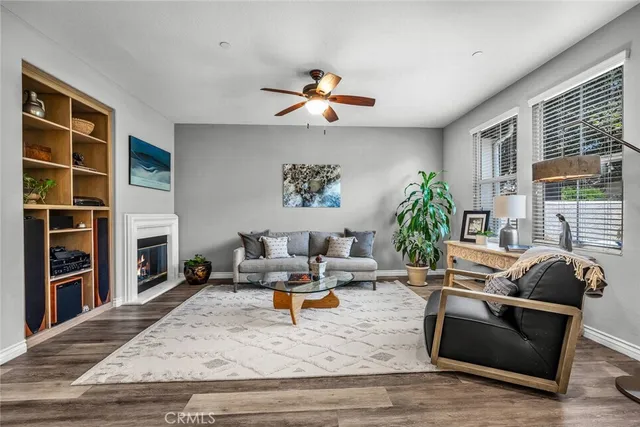 a living room with fireplace furniture and a wooden floor