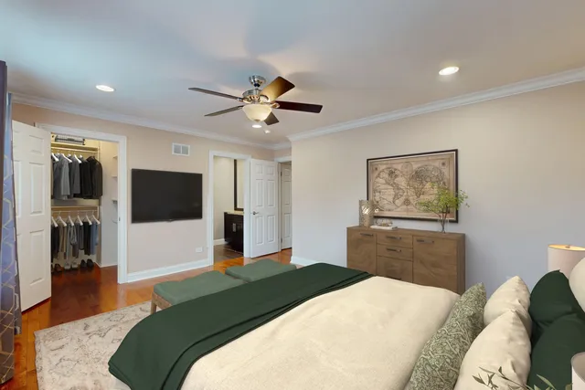 a bedroom with a bed and a lamp on dresser