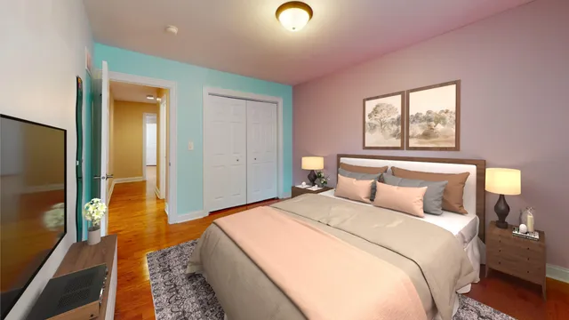 a bedroom with two beds and a flat screen tv