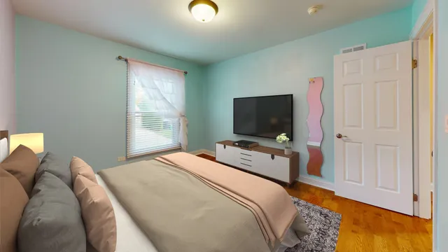 a bedroom with furniture and a flat screen tv