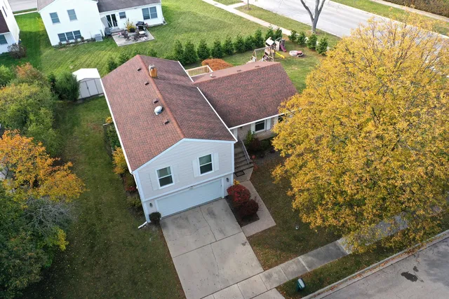 an aerial view of a house with a yard