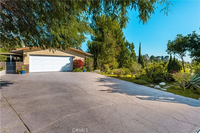 a view of a house with a yard and garage