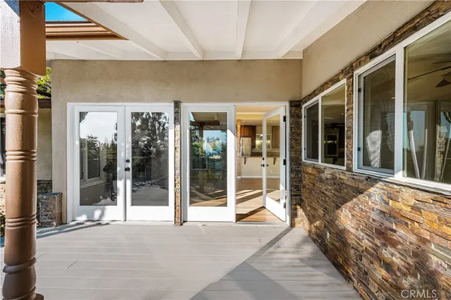 a view of a kitchen with kitchen island a counter top space and stainless steel appliances