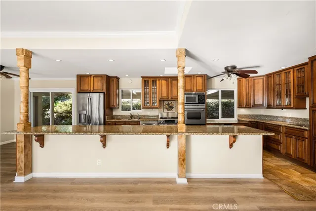 a bathroom with a granite countertop sink a mirror and a bathtub