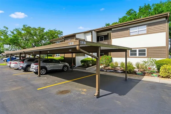 a view of a patio with table and chairs under an umbrella