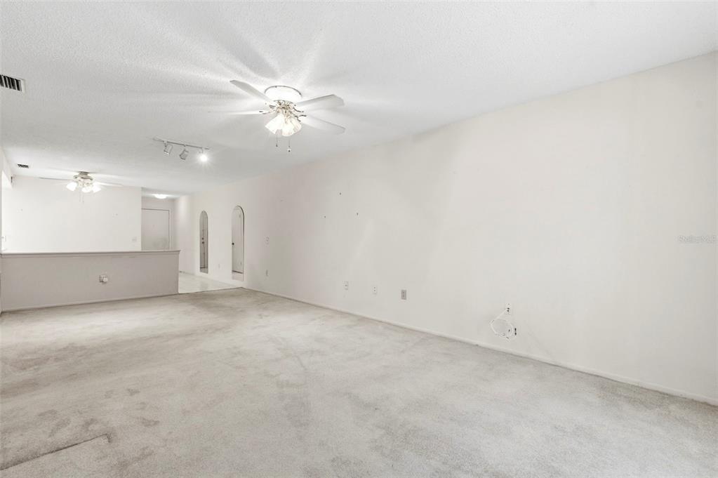 4101 Passport Lane, Unit 203 New Port Richey, FL 34653 - Photo 20 of 83 an empty room with a ceiling fan and a bathroom