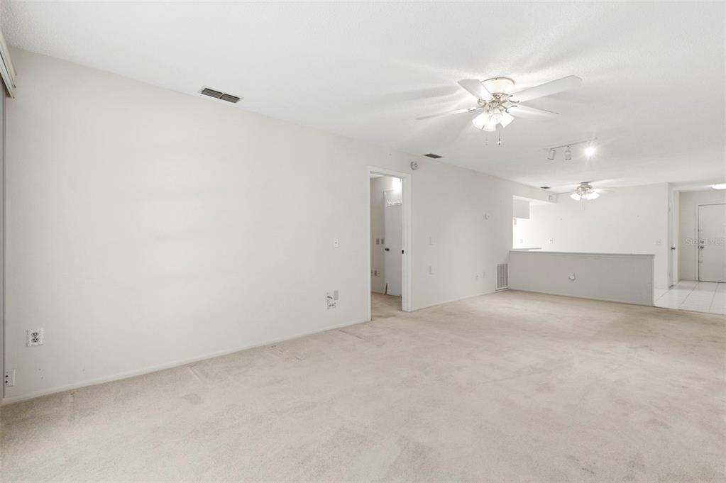 4101 Passport Lane, Unit 203 New Port Richey, FL 34653 - Photo 21 of 83 an empty room with a ceiling fan and a bathroom