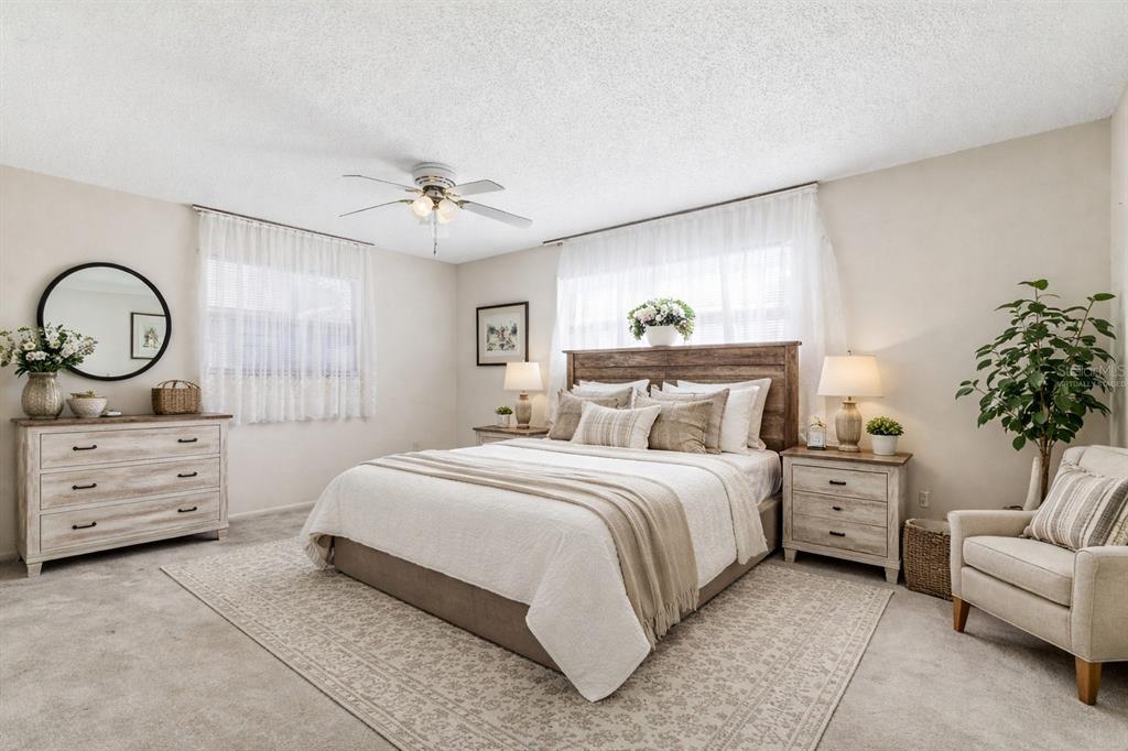 4101 Passport Lane, Unit 203 New Port Richey, FL 34653 - Photo 25 of 83 a spacious bedroom with a bed and a dresser