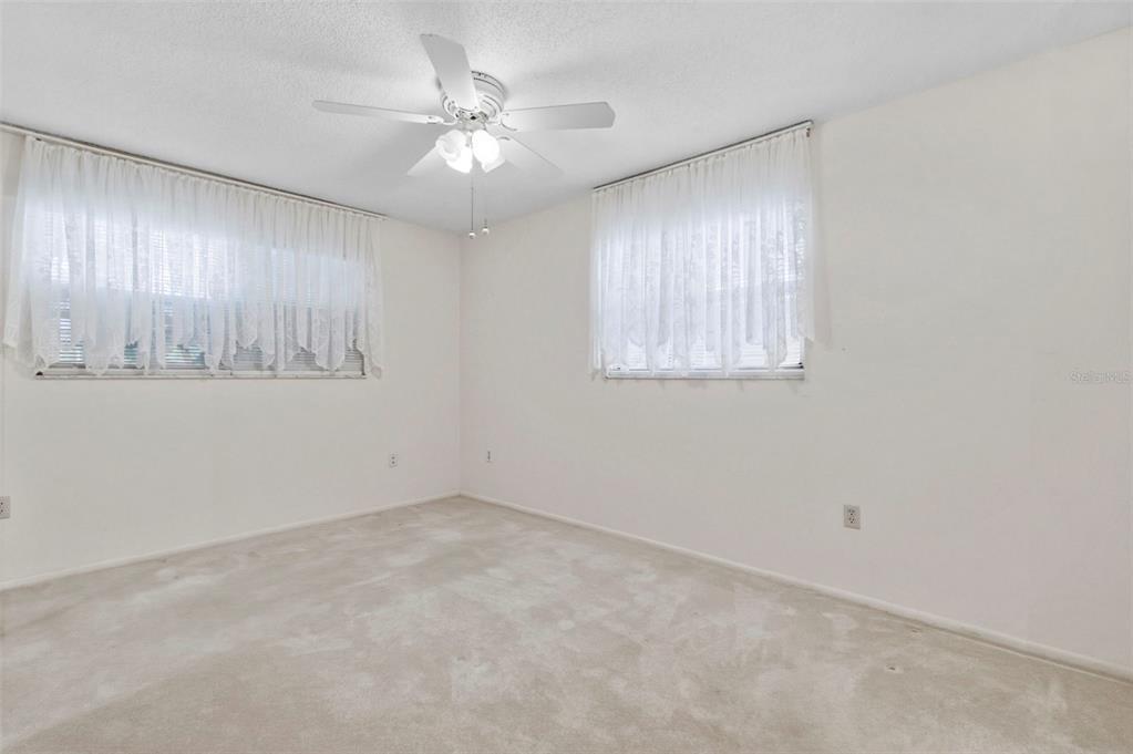 4101 Passport Lane, Unit 203 New Port Richey, FL 34653 - Photo 26 of 83 an empty room with windows and fan