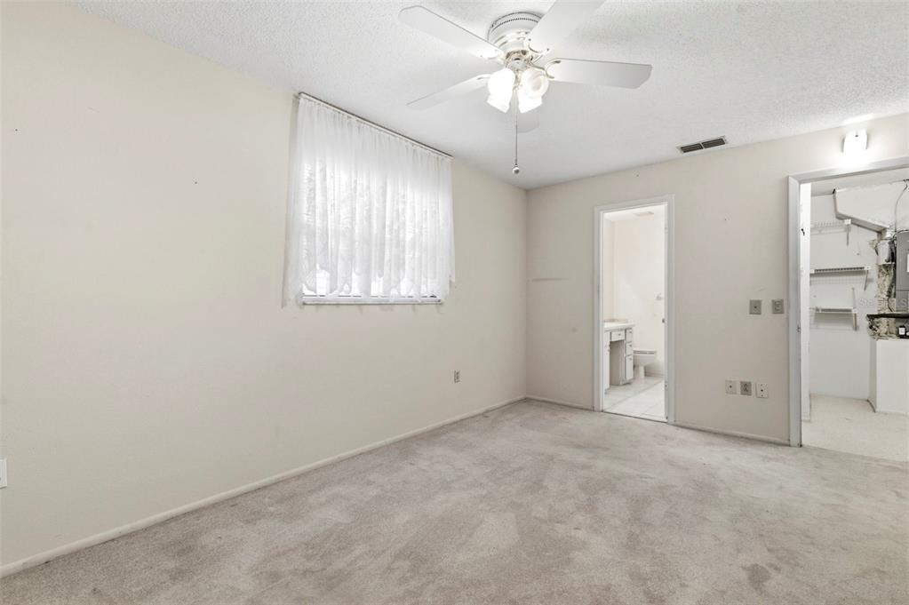 4101 Passport Lane, Unit 203 New Port Richey, FL 34653 - Photo 27 of 83 an empty room with chandelier fan and windows