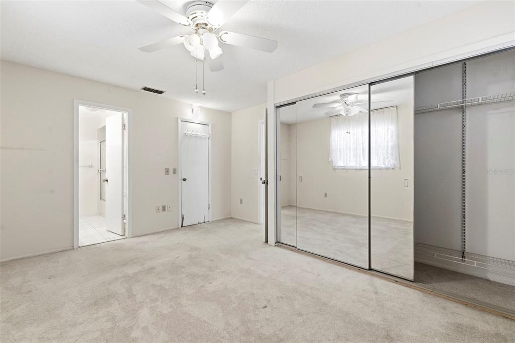 4101 Passport Lane, Unit 203 New Port Richey, FL 34653 - Photo 28 of 83 an empty room with closet and a chandelier fan
