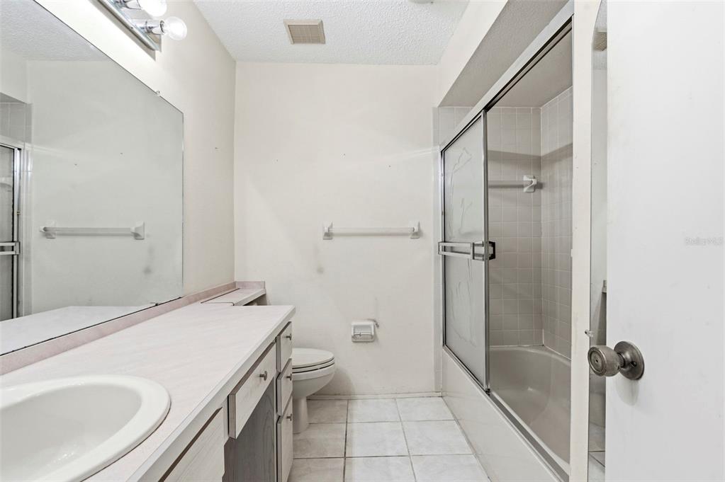 4101 Passport Lane, Unit 203 New Port Richey, FL 34653 - Photo 30 of 83 a bathroom with a sink toilet and shower